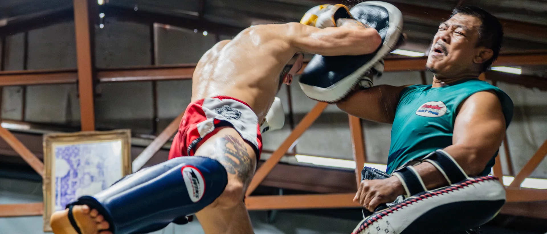 Flying knee on the pads at Kiatphontip Muay Thai camp, Bangkok