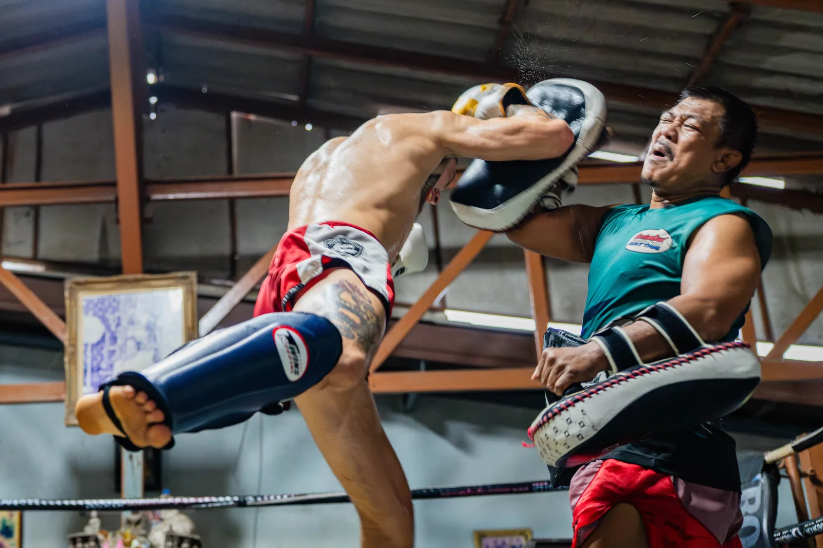 Fighter throwing a flying knee during pad work