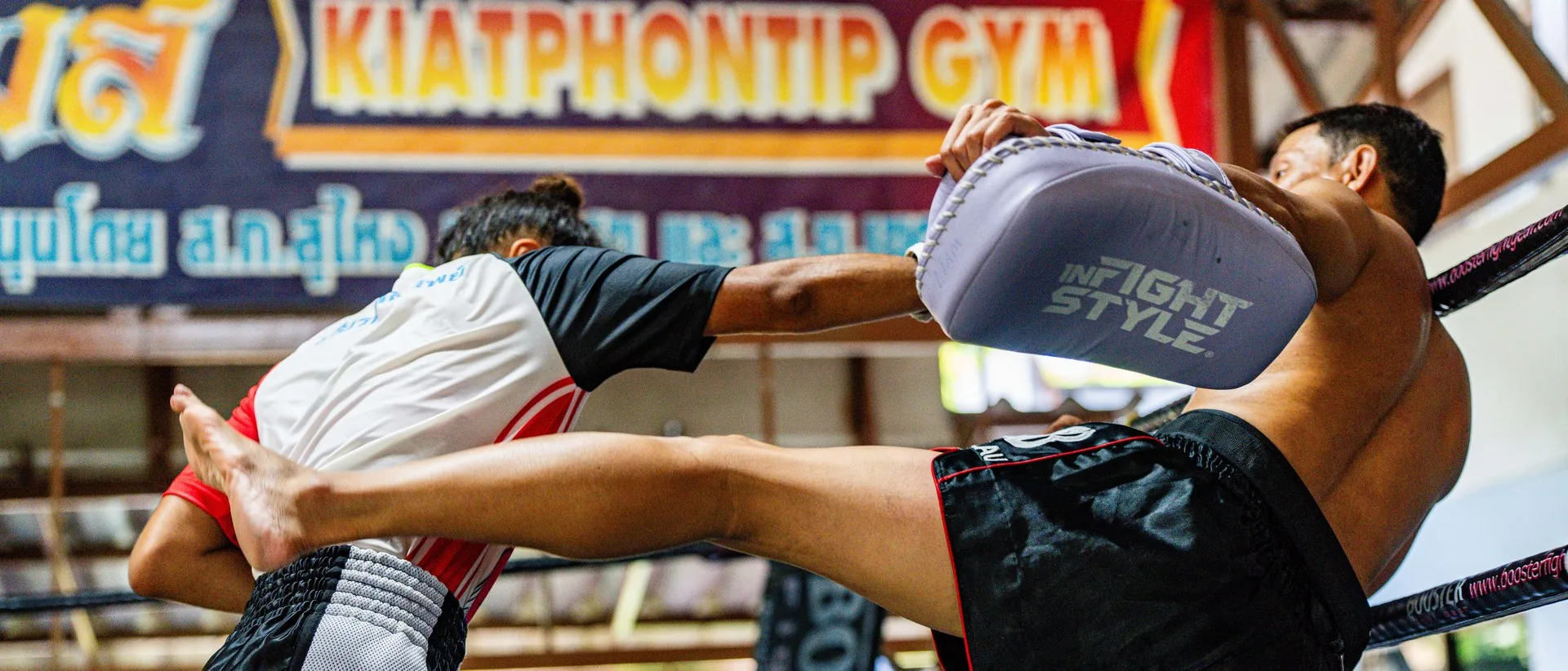 High kick on the pads under the Kiatphontip Gym sign, Bangkok