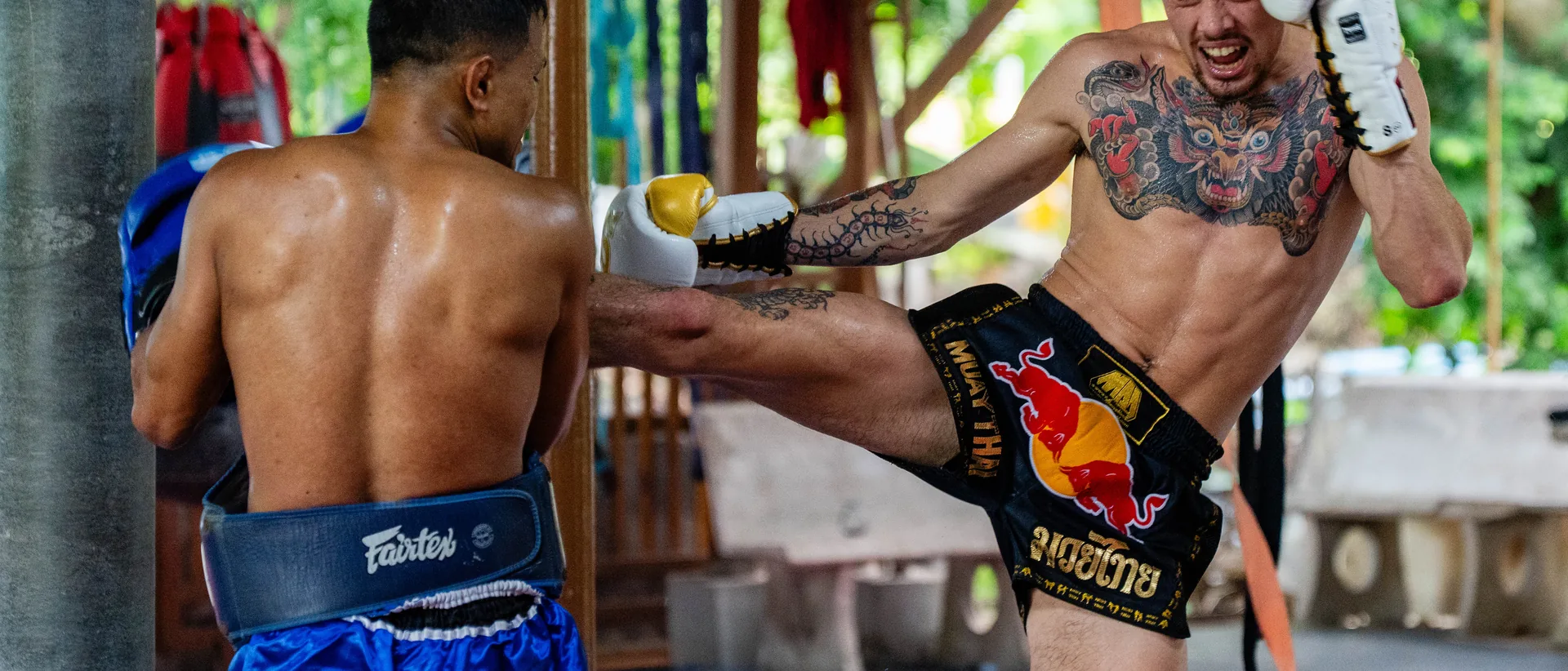 Kicking the pads during a training round at Kiatphontip Muay Thai camp, Bangkok