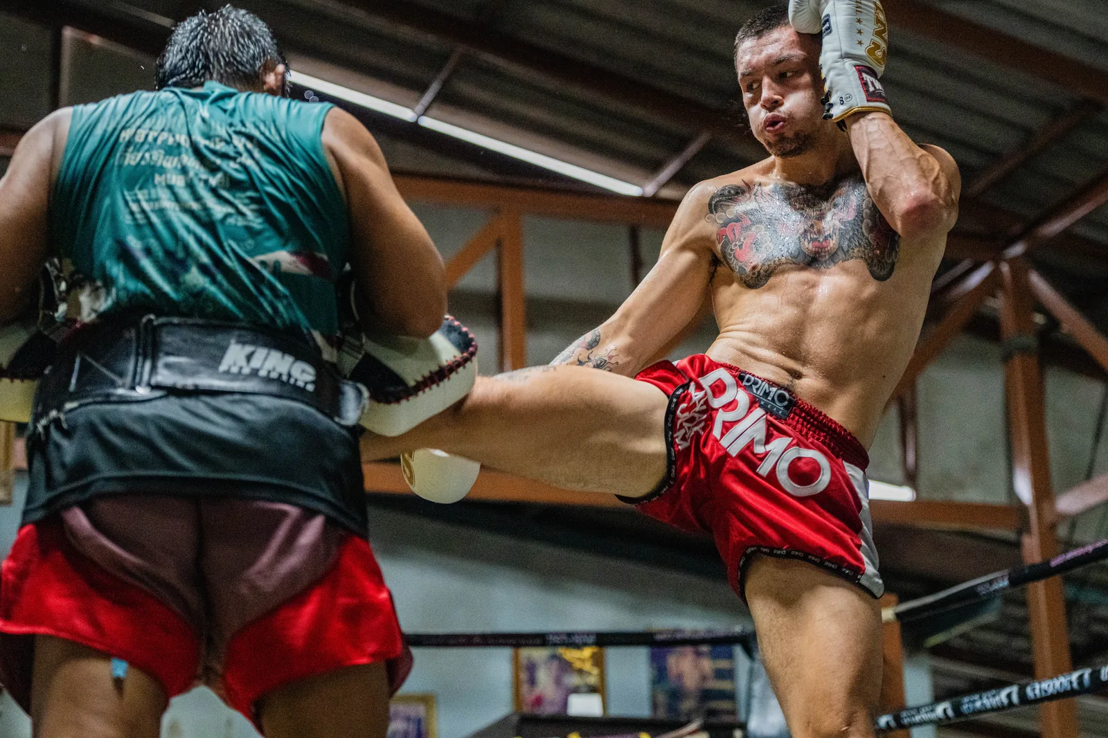 Knee strike as the kru holds the pads